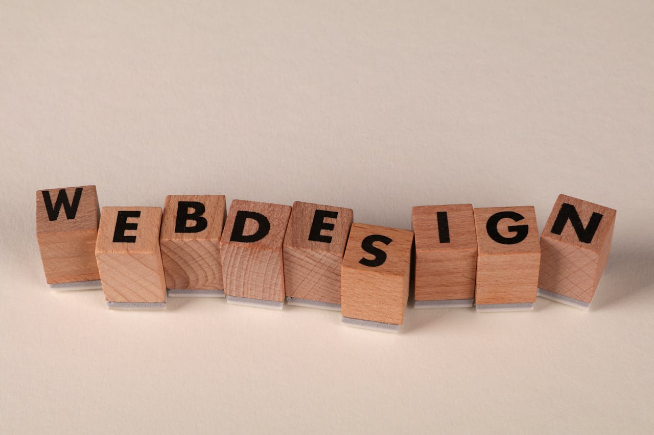 Wooden blocks spelling 'web design' creatively showcase digital design concept.
